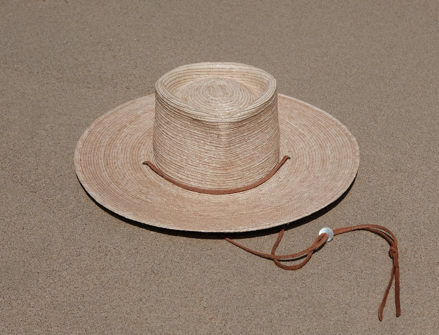 Jack Savage Wayfinder Palm straw hat on a beach